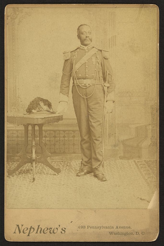 [African American soldier, full-length portrait, wearing GAR medal, standing next to table], 1880 (Library of Congress)