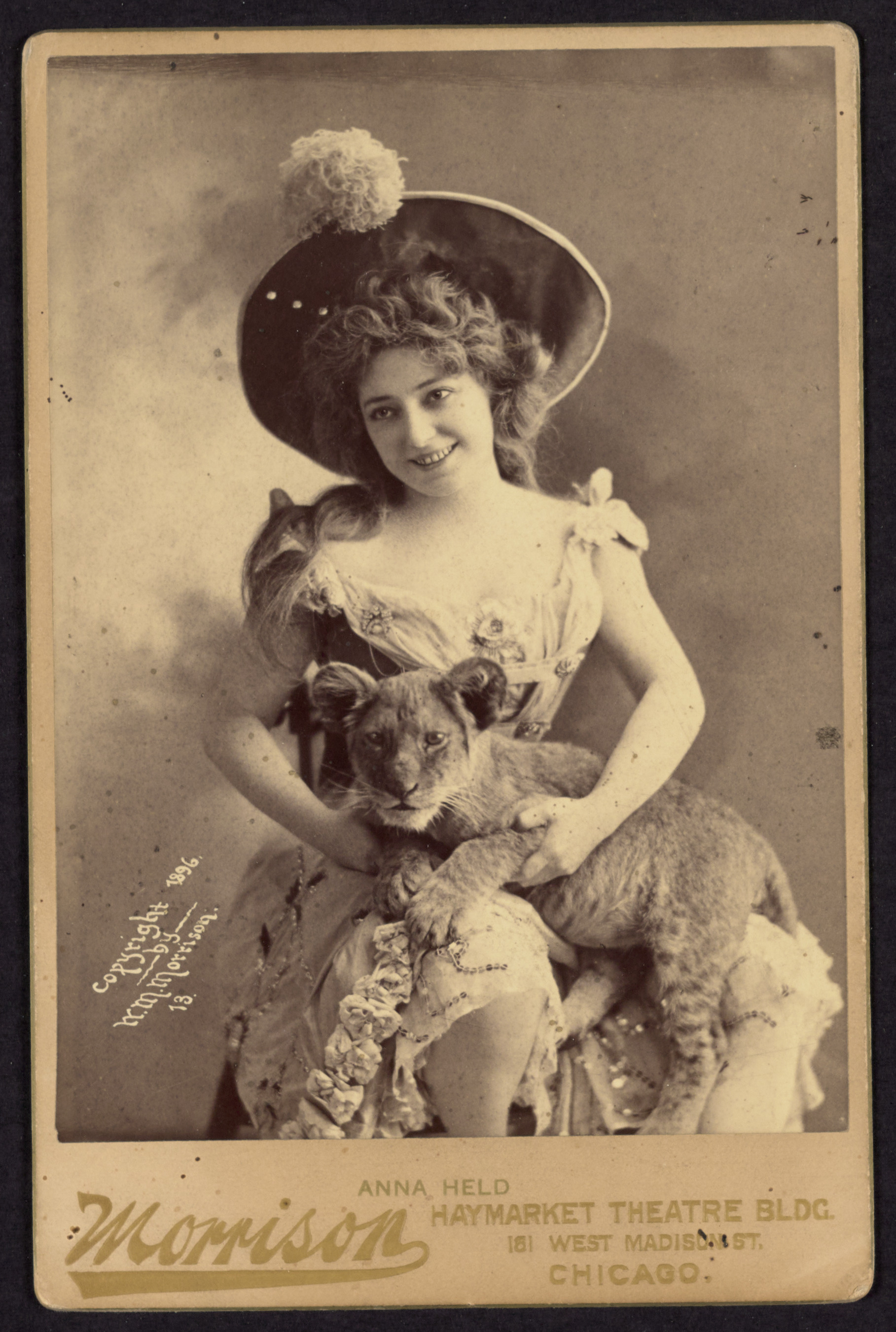 Anna Held posing with lion, 1896 (Internet Archive)