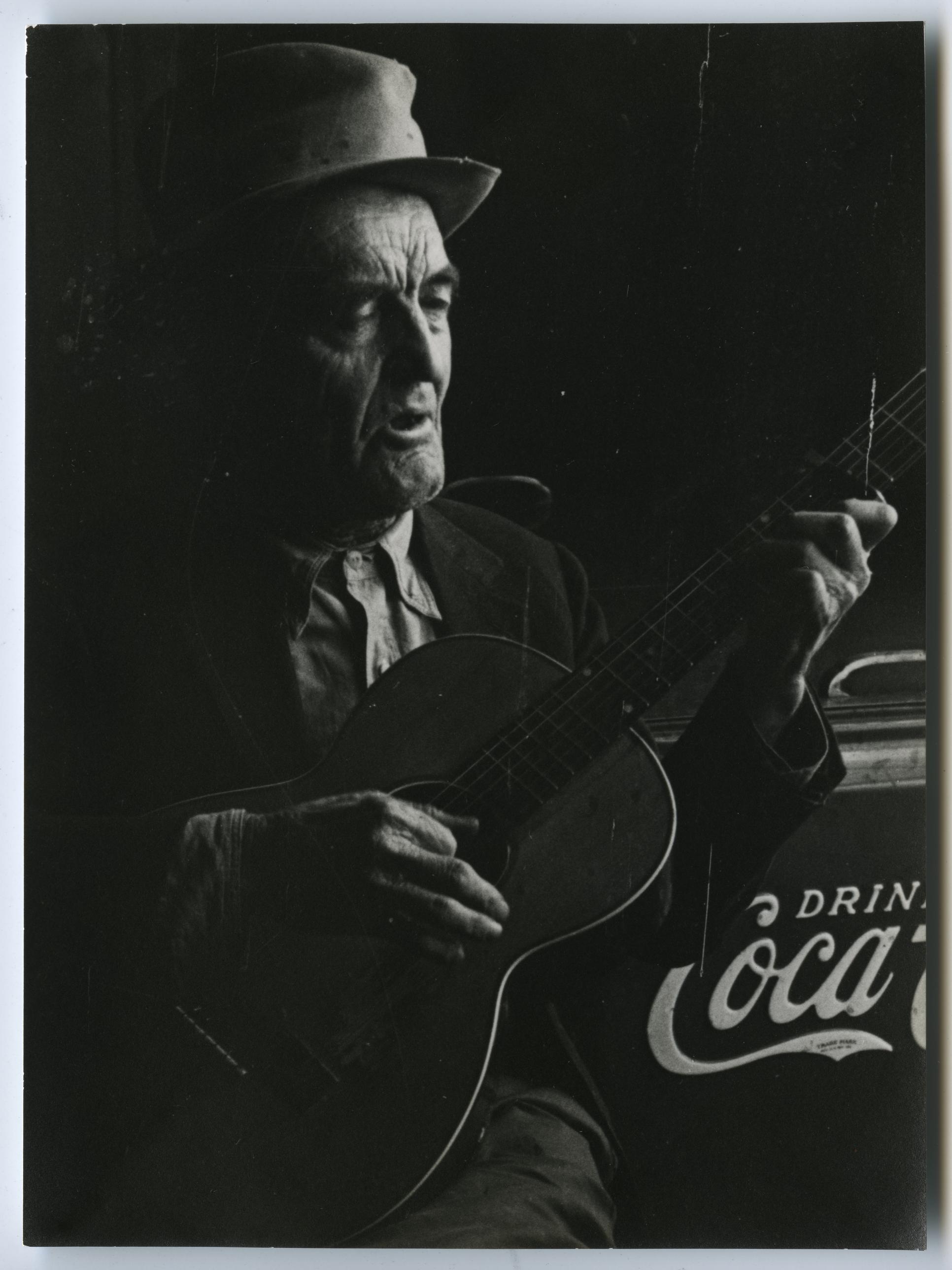 Ben Pitts playing guitar, seated, 1939 (Library of Congress)