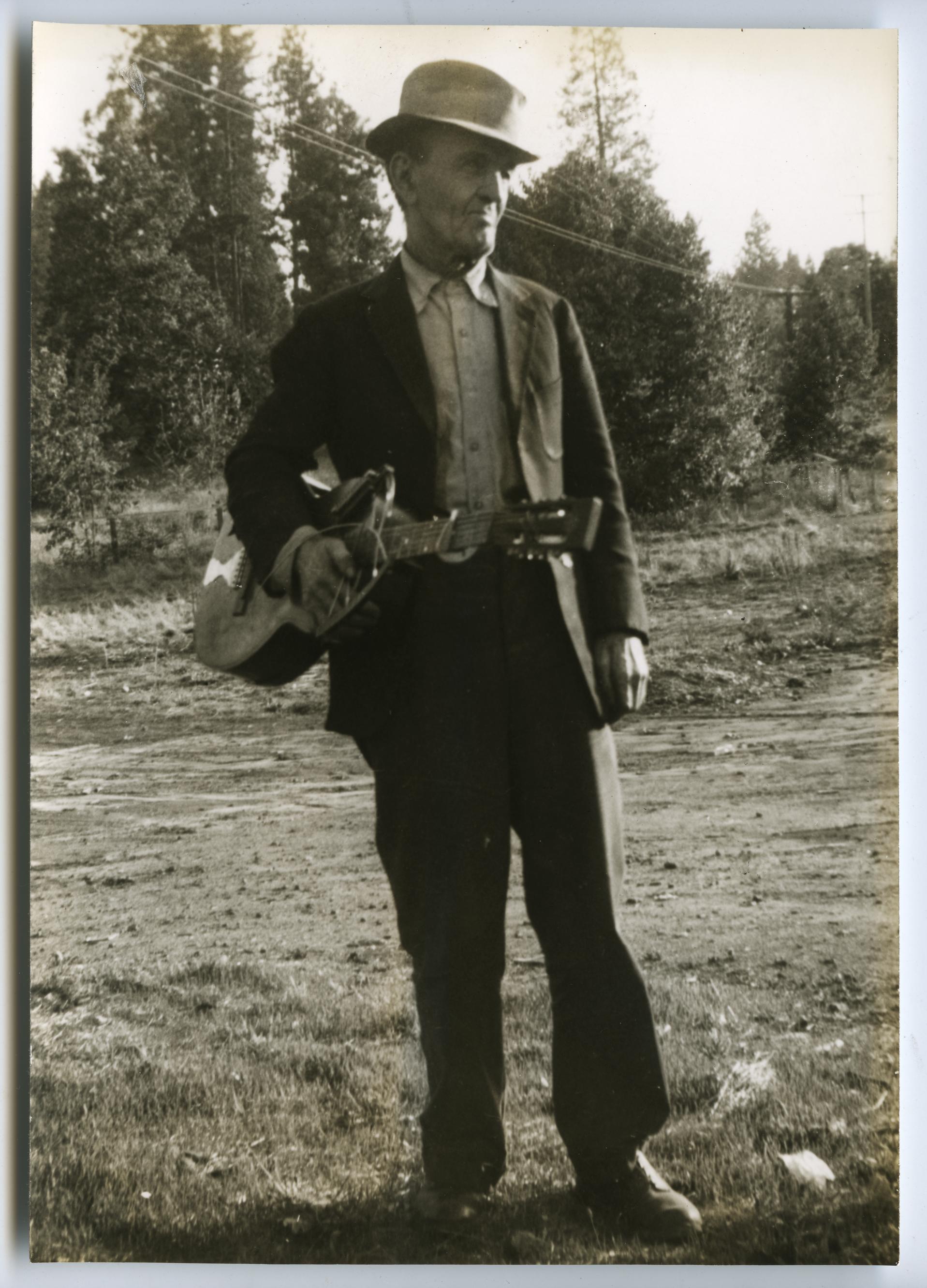 Ben Pitts standing with guitar, 1939 (Library of Congress)