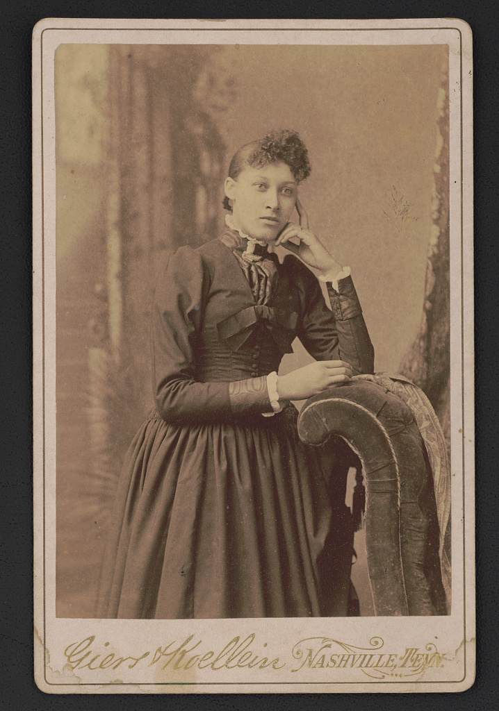 [Portrait of journalist, Lillian Parker Thomas, standing before studio backdrop], 1890 (Library of Congress)
