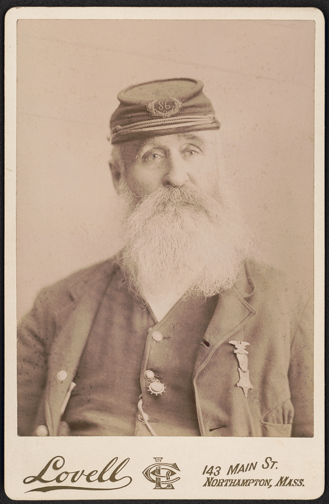 [Unidentified Civil War veteran with Grand Army of the Republic medal, kepi with post 86 insignia, and watch fob in his button hole], 1905 (Library of Congress)